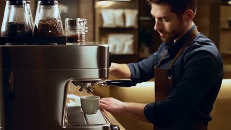 a barista prepares coffee with an espresso machine