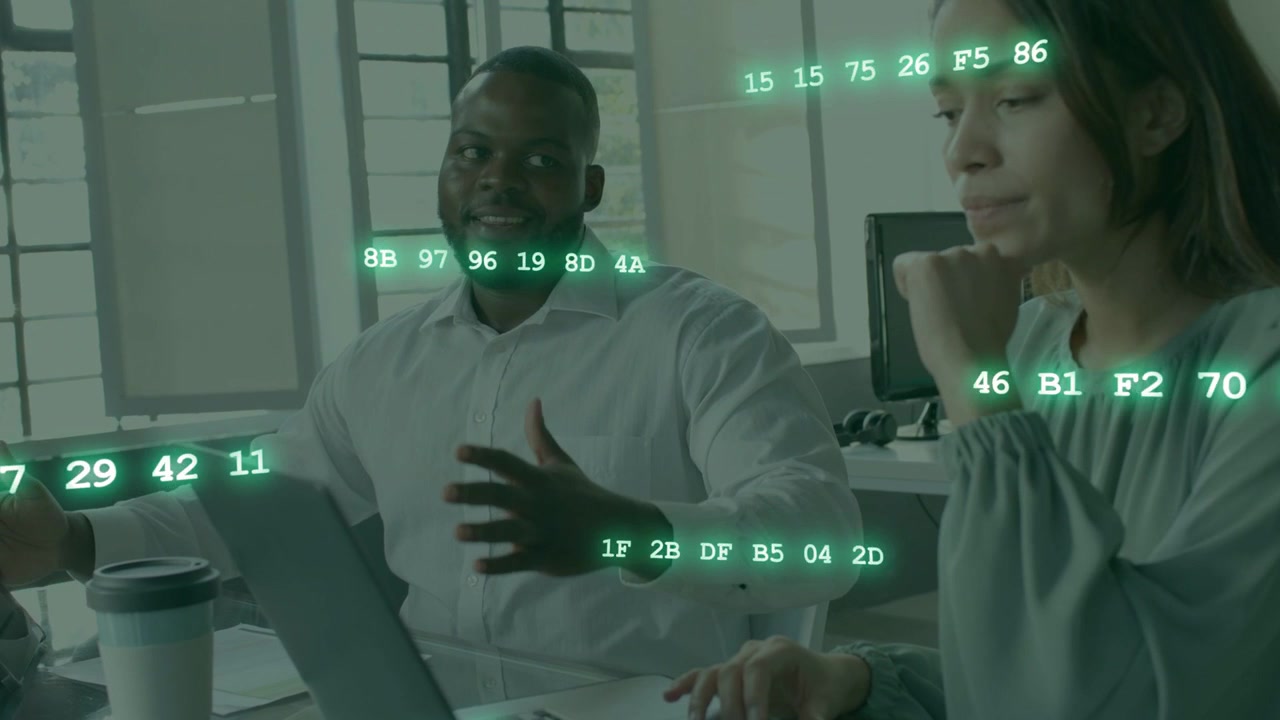 Pair typing on laptop, left man gesturing causing hex data overlay growing driving code review