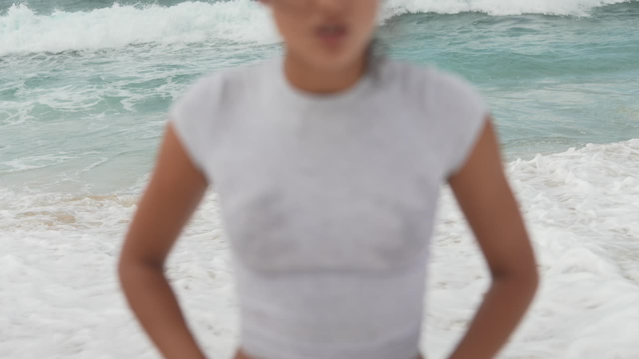 Woman on the beach with waves