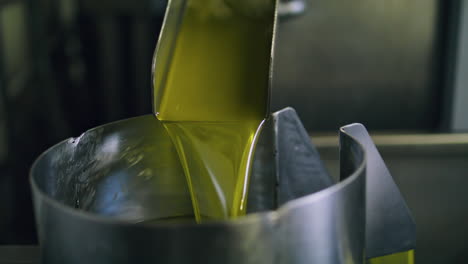 olive oil machine working at factory closeup. product pouring tank bin vertical