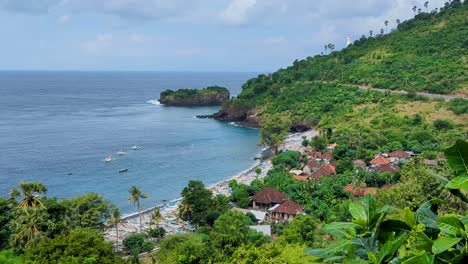 scenic aerial view of sheltered bay, fishing boats, ocean, and green landscape with glimpse of gili selang lighthouse at easternmost point of bali, indonesia
