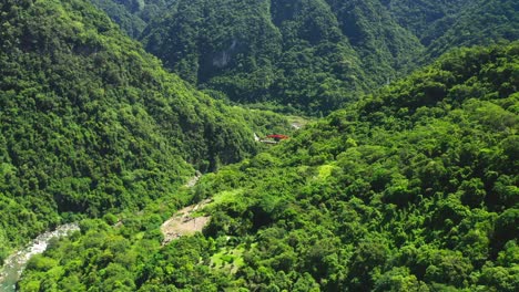 Aerial-view-of-Suspension-Bridge-behind-greened-mountains-in