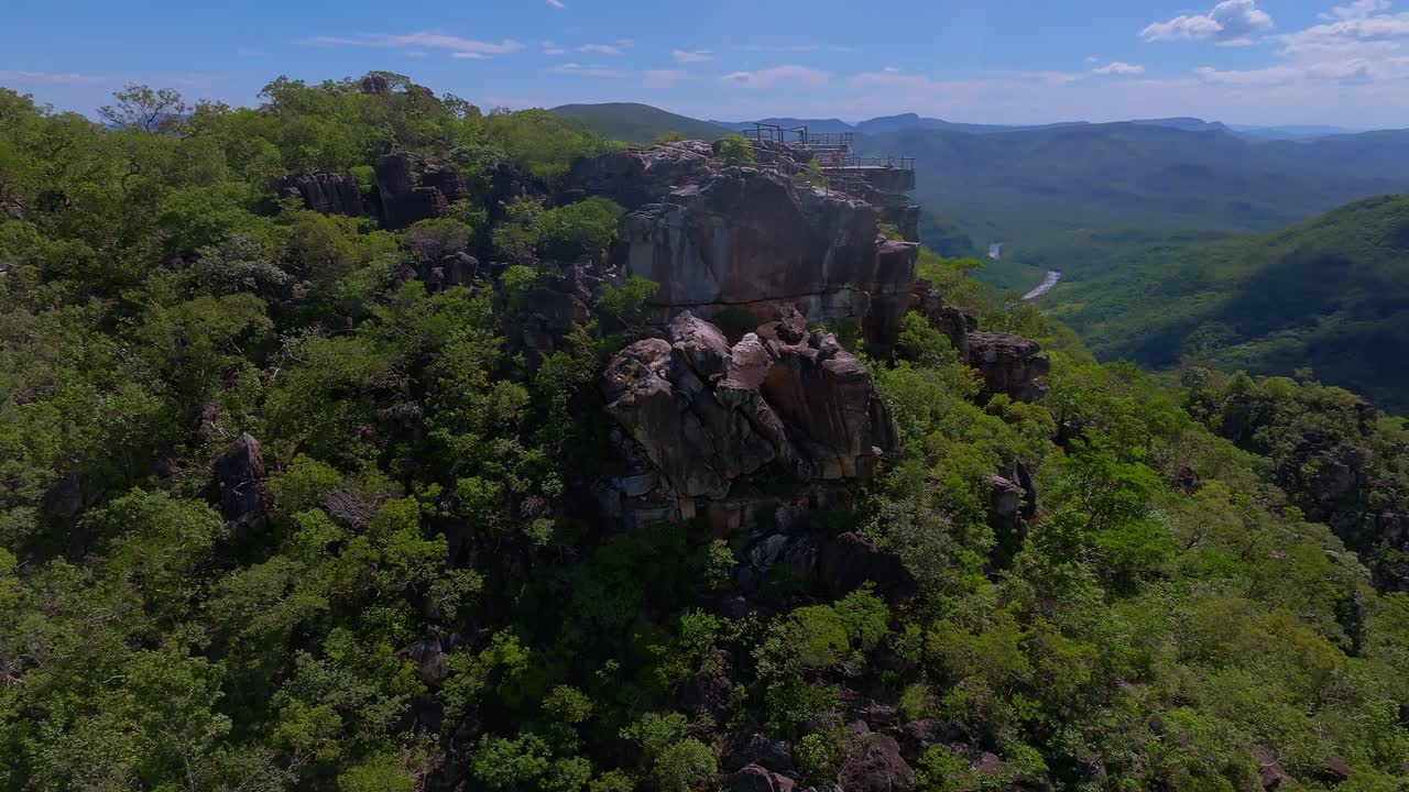 Aerial view capturing Cachoeira dos Saltos in Goiás, Brazil, with lush vegetation enveloping rocky cliffs and canyons, dolly in drone shot and reveal
