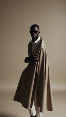 stylish man in beige trench coat and sunglasses