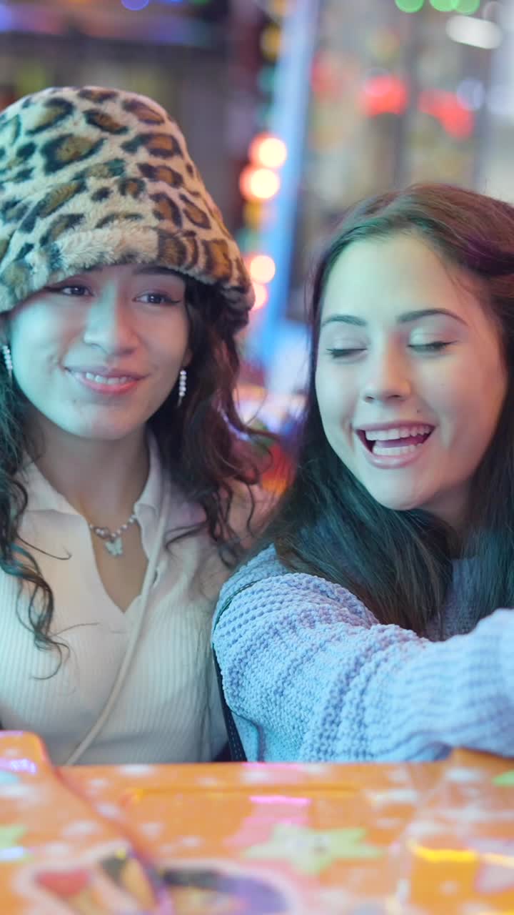 Two joyful friends having fun at an amusement park