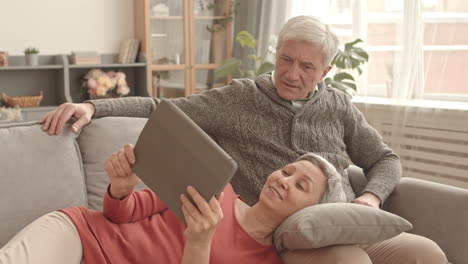 senior couple using tablet at home