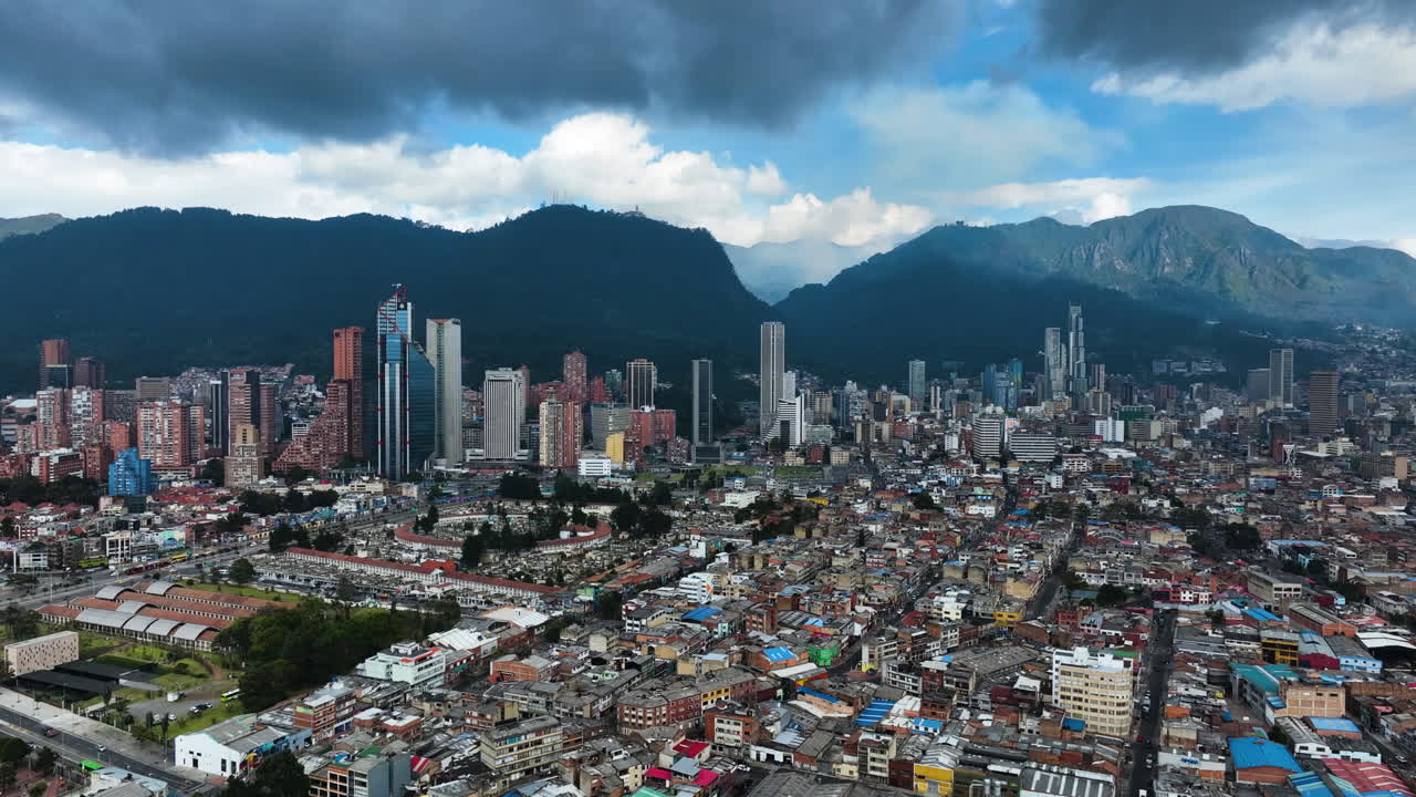 Aerial view rising toward the Bogota city skyline, dark clouds in Colombia