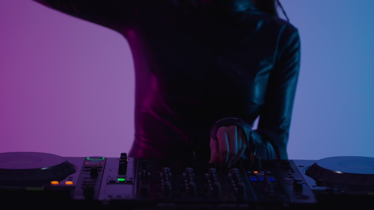 una mujer dj mezcla música en tocadiscos en un club.