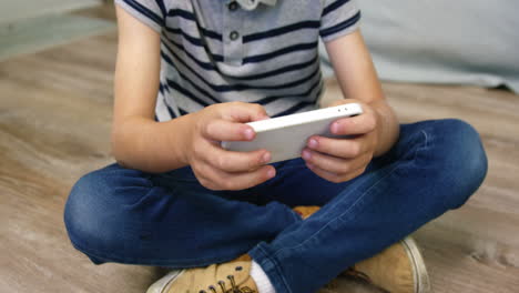 a boy playing games on smartphone