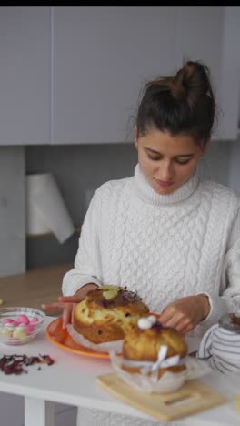 woman decorating easter cakes in a kitchen