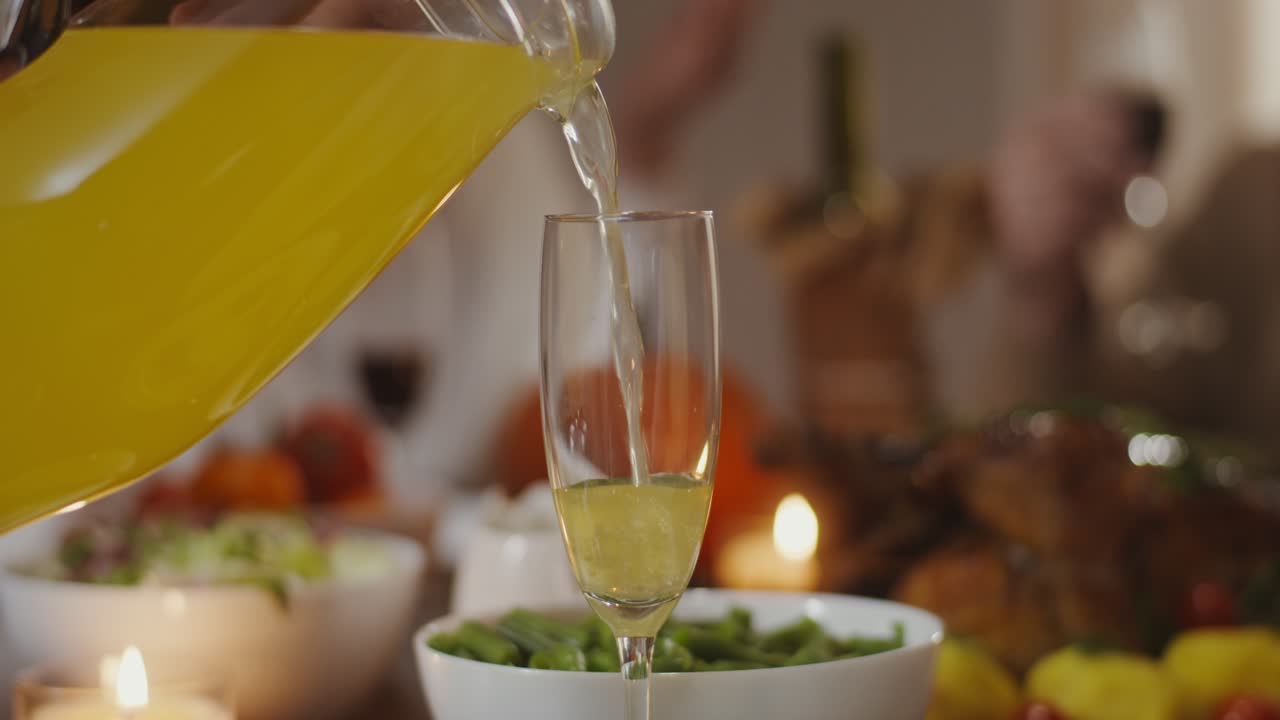 Pouring Juice at a Thanksgiving Dinner