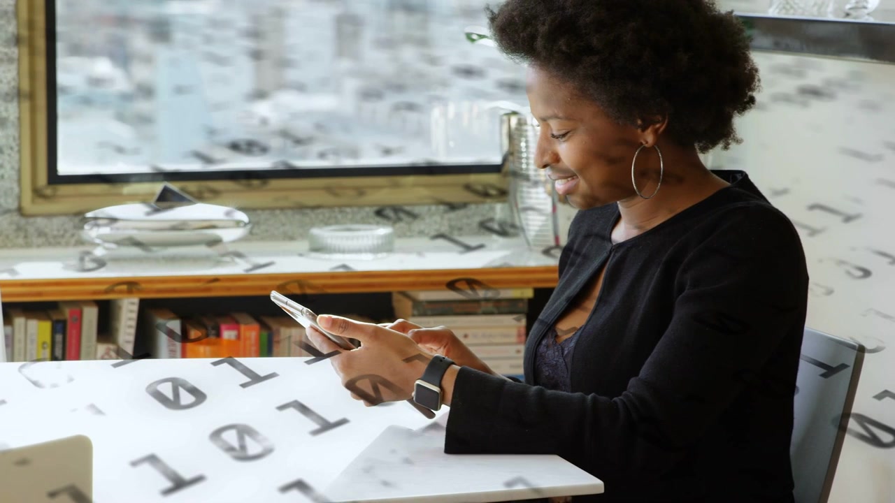 Woman tapping phone at table, checking messages while tech binary overlay animating around phone