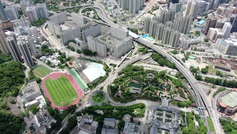 Hong-Kong-bay-and-skyline-with-skyscrapers,-high-altitude-wide-shot