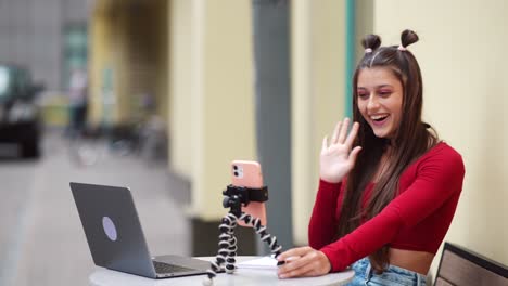 young woman on video call at a cafe