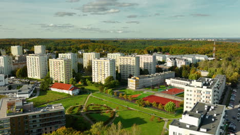aerial view of apartment buildings and green space in a city