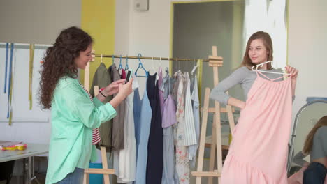 dressmaker taking photo of client.