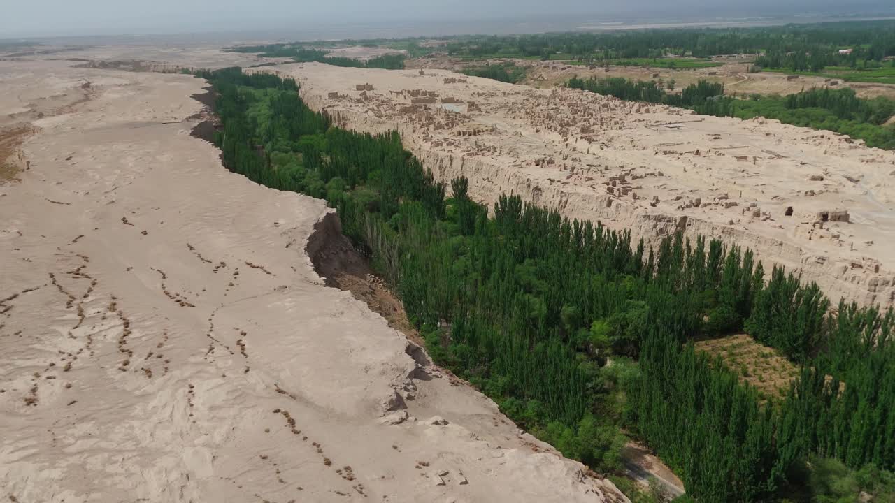 Establishing Aerial drone fly Yarkhoto (Jiaohe) Ruins on Plateau in Yarnaz Valley, China