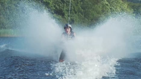 Barefoot-water-skiing-on-long-line-behind-speed-boat-on-river