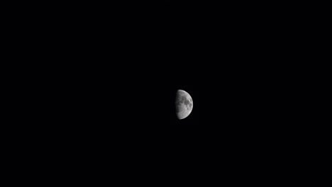 half a moon in the darkness of space