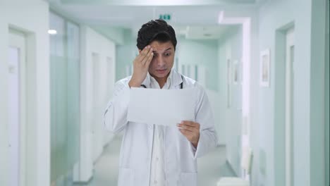 Stressed-Indian-doctor-checking-medical-reports