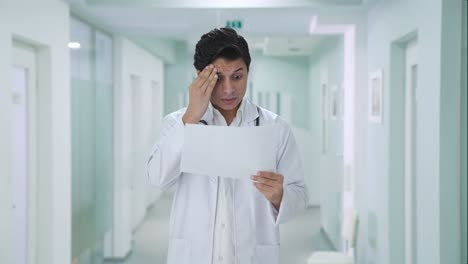 stressed indian doctor checking medical reports