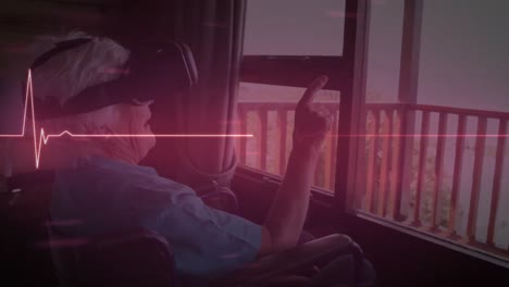 Glowing-red-heart-rate-monitor-against-caucasian-senior-woman-on-wheelchair-wearing-vr-headset