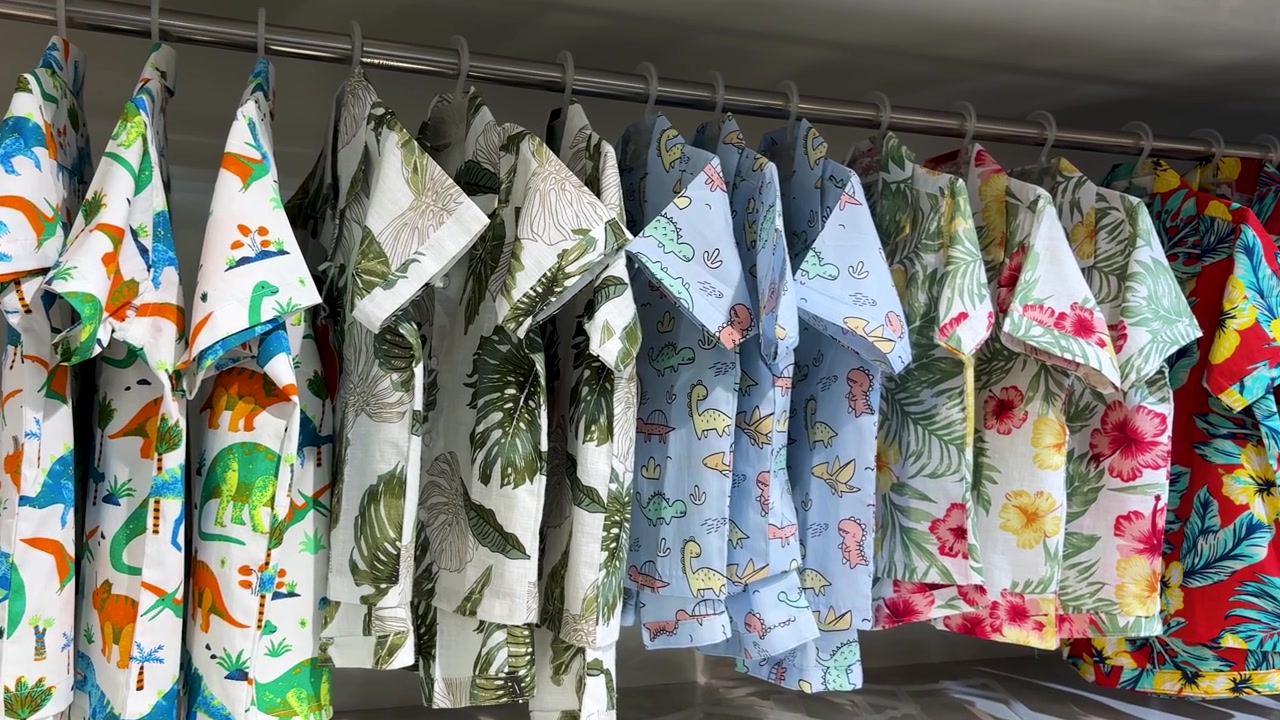 Colorful Kids Tropical Shirts Hanging On Clothing Rack In Children Fashion Store