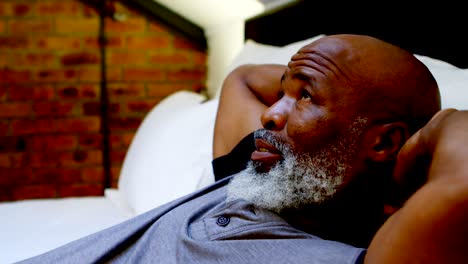 senior man relaxing in bedroom at home 4k