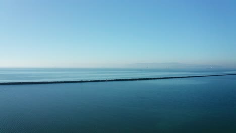 incredible view of the breaker wall in the bay with blue skies and sunny day