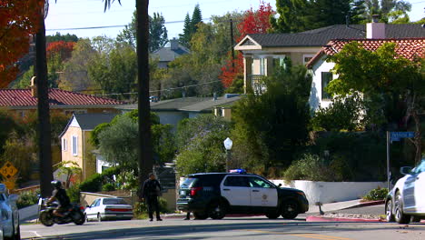 police redirect traffic in an urban neighborhood