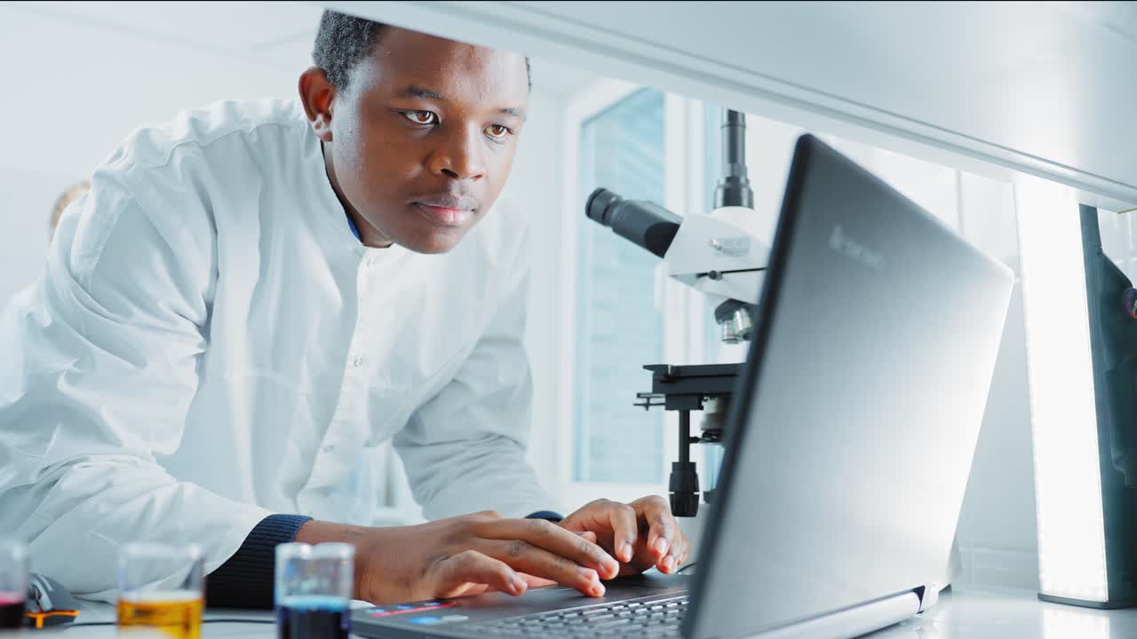 Scientist Working on a Laptop in a Laboratory