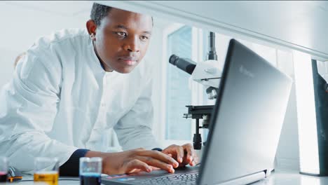 scientist working on a laptop in a laboratory
