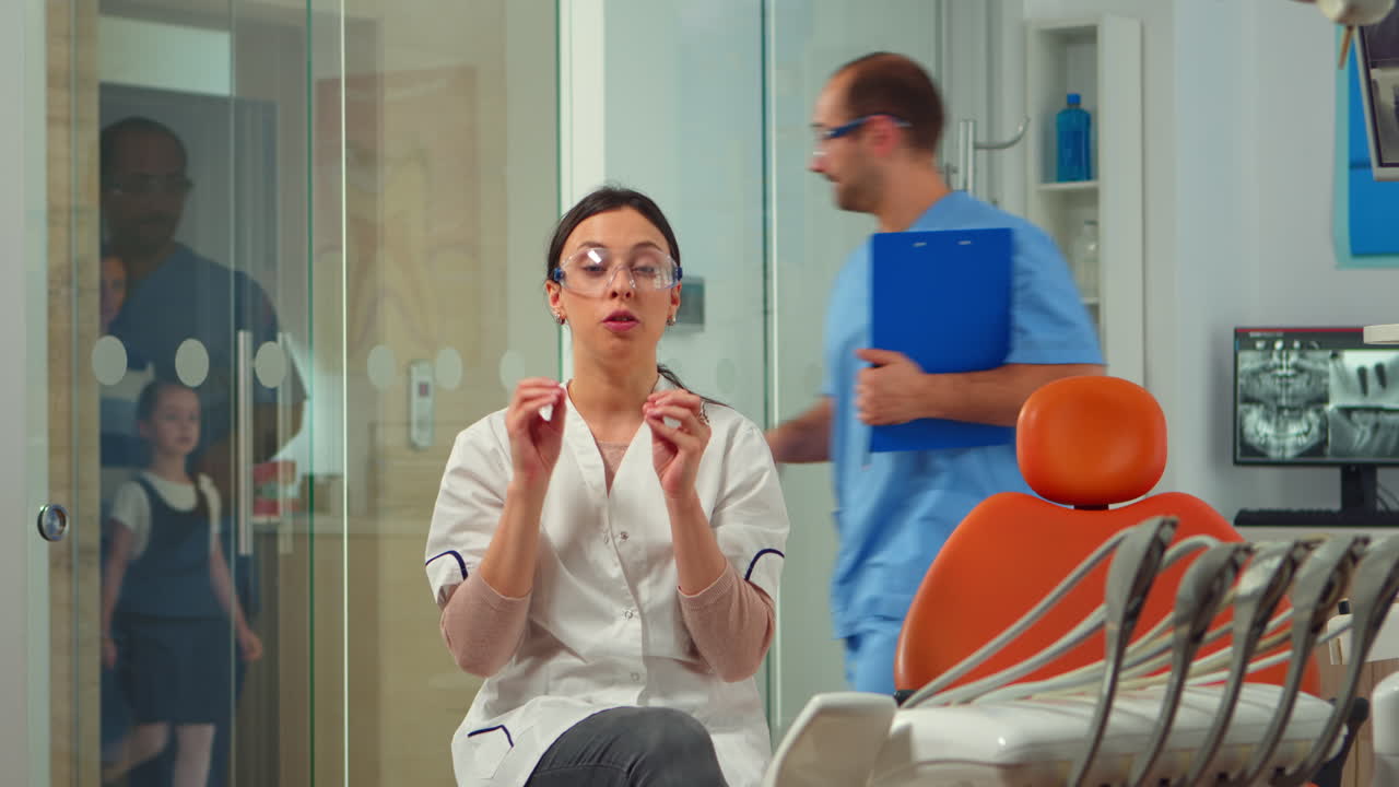 Woman stomatologist speaking on video camera