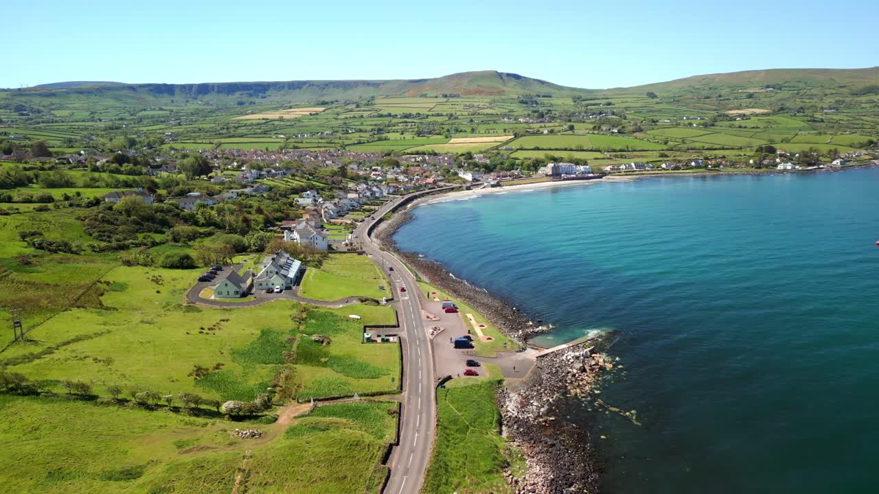 Wide, overhead aerial video of the Antrim Coastal Route on a bright and sunny day. Filmed in Ballygally in 4K, 60FPS and with Rec800 color.