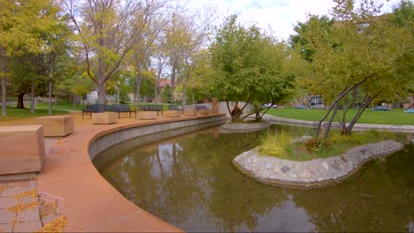 Golden-leaves-falling-at-a-pond-in-a-city-park