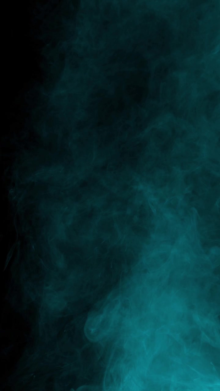 Swirling cyan arctic fog and smoke. Isolated on black background, ideal for compositing, vertical format