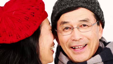 mature asian couple holding coffee cups and talking