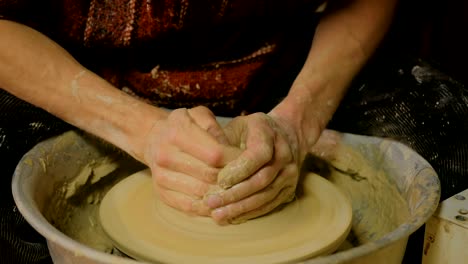 professional male potter working in workshop