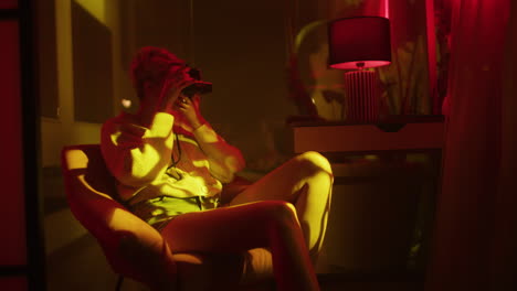 woman taking polaroid photo in a night-time interior
