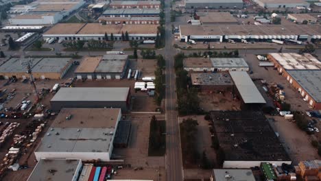 Lonely-semi-truck-crossing-an-intersection-in-the-abandoned-industrial-zone-with-polluted-air