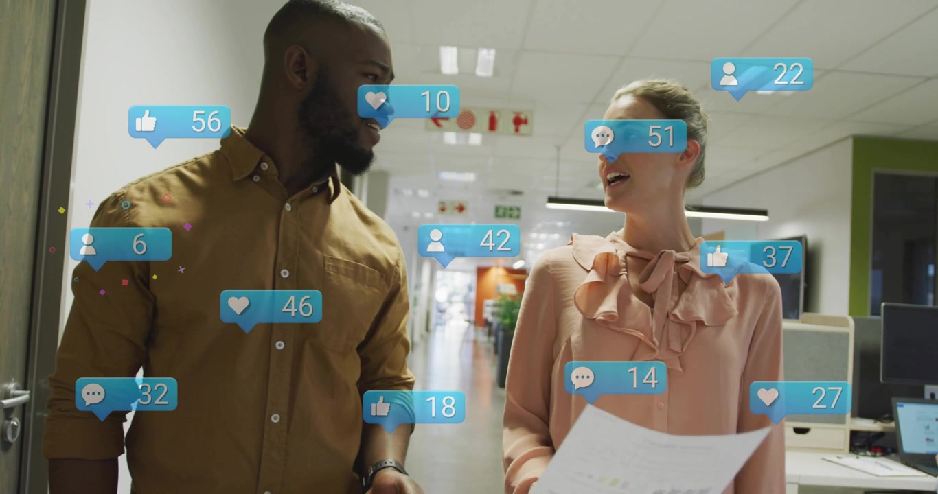 Two coworkers reviewing charts in marketing corridor, initiating like bubbles rising while walking