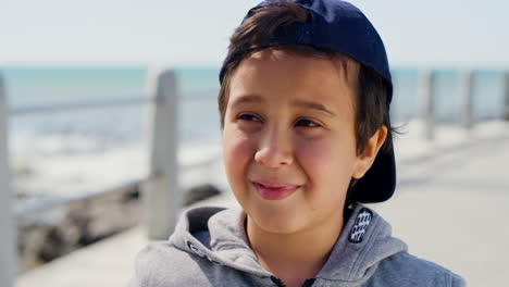 smile, beach and face of child at ocean