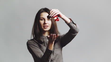 girl blowing multicolor confetti. young woman celebrating and blowing confetti decorations