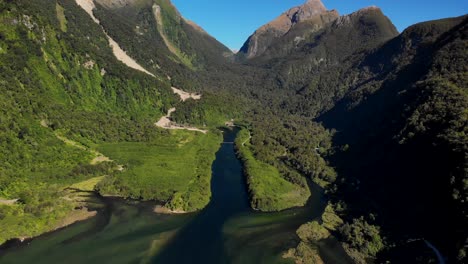 aerial view of green mountains and wanganella cove at doubtful sound fjord in southland, new zealand