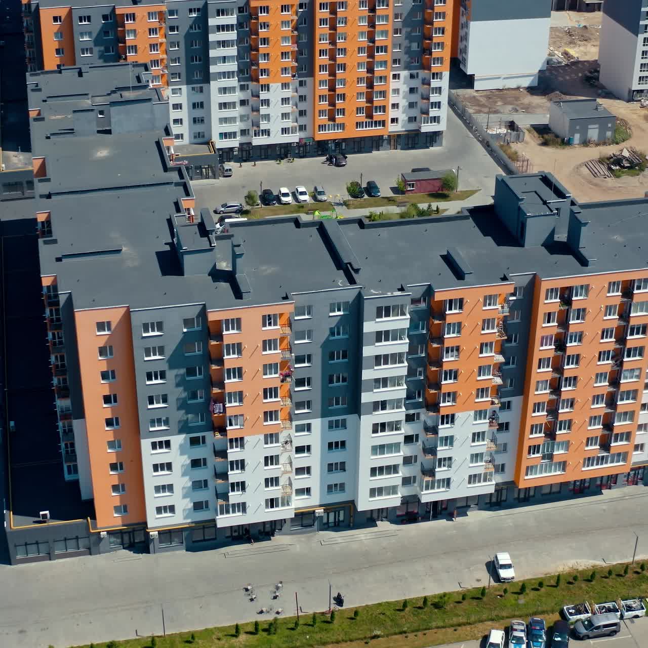 New modern apartment building. Multi-storey architecture in the city. New urban housing. Residential block of flats. Aerial view. Top down
