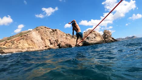 a sportsman keeps balance over a slack line