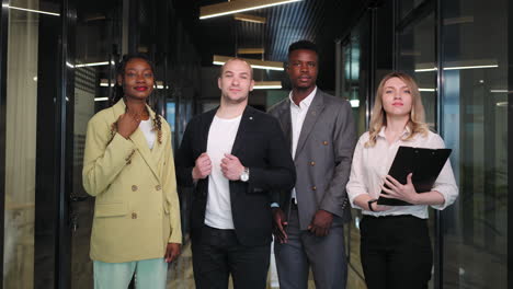 confident happy diverse business people together in office corporate portrait looking at camera. multiethnic professional employees executives group posing together for corporate portrait