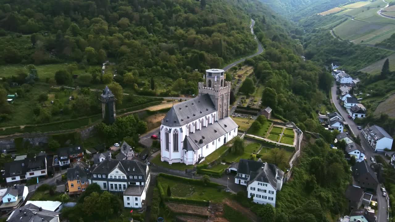 Drone view of fortified military church and town wall towers in Oberwesel, Germany