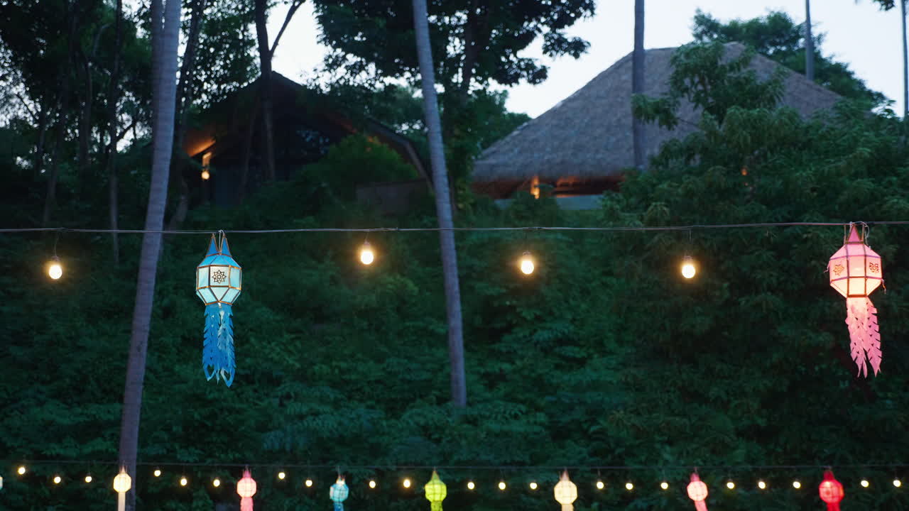 Night Lanterns and Cabins in Tropical Setting