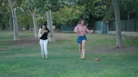 two women having fun in a park